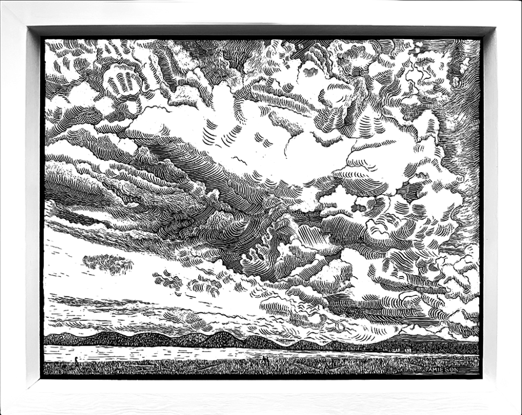 B&W print of storm clouds looming over a beach